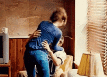 A couple embraces while one person sits on the other's lap.