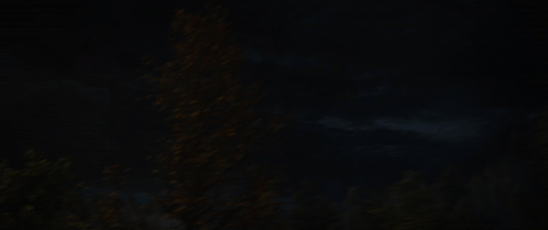 a blurred image of a light coming out of a window