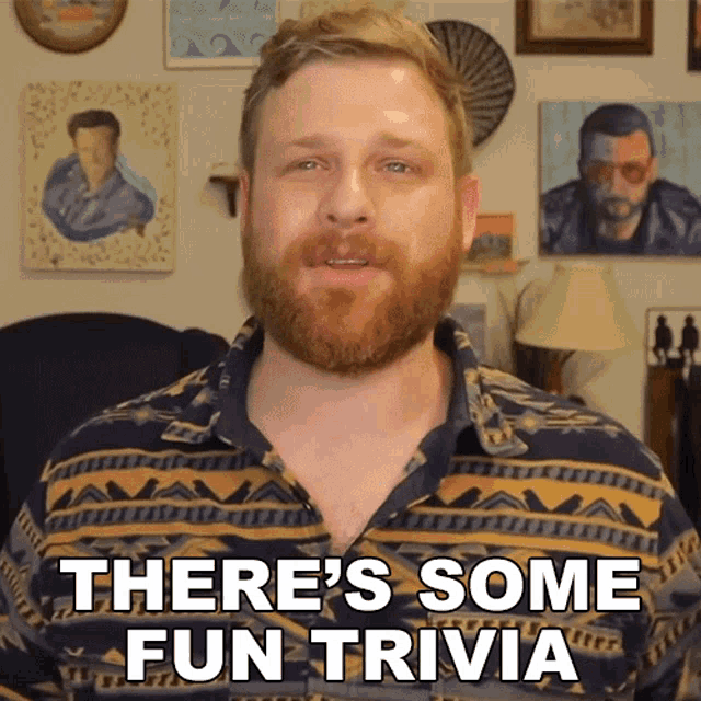 a man says there 's some fun trivia in front of a wall of paintings