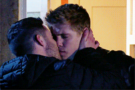 two men are hugging and kissing each other
