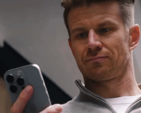 a man is holding a cell phone in his hand