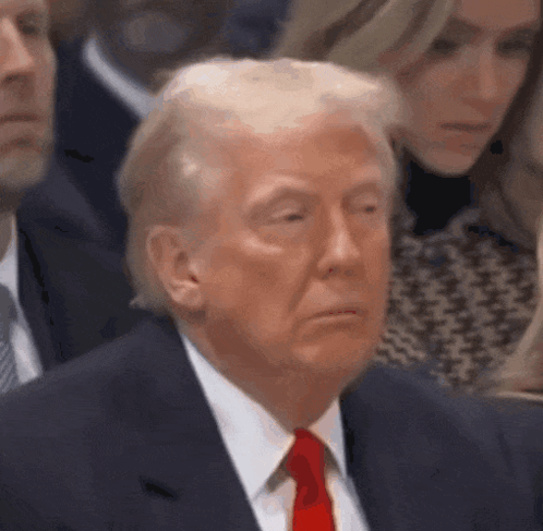 Donald Trump closes his eyes and looks sleepy.