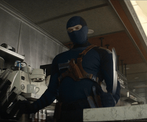 a man in a mask is standing in a kitchen with the words daredevilshots written on the bottom