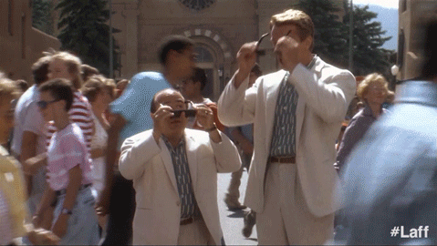 two men in suits are taking a picture of a crowd with #laff written on the bottom