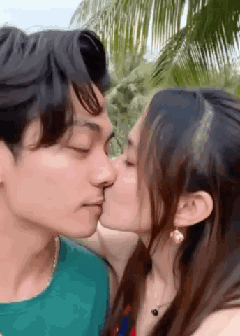 A young couple kisses outdoors with “GOOD NIGHT” text.