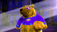 a stuffed animal wearing a purple and yellow shirt with the number 5 on it