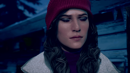 a woman wearing a red beanie and a purple turtleneck