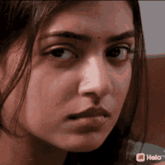 A woman gives a stern, displeased sideways look.