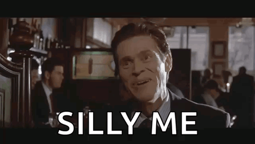 Willem Dafoe as Paul Allen looks forward in an American Psycho scene captioned “SILLY ME”.