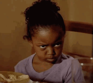 A child gives an intense angry stare toward the camera.