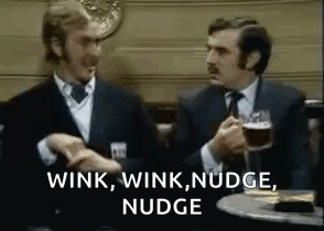 Two suited men exchange a conspiring look under “WINK, WINK, NUDGE, NUDGE” text.