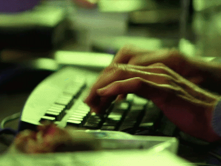 a person is typing on a keyboard with the shift key in the middle