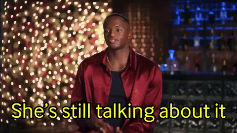 a man in a red jacket is talking to a woman who is still talking about it .
