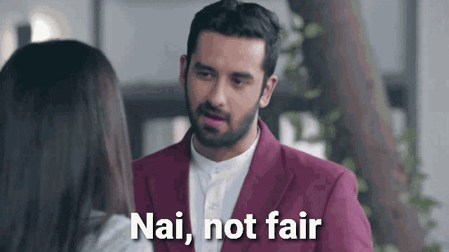 a man in a purple suit is talking to a woman and the words nai not fair are visible