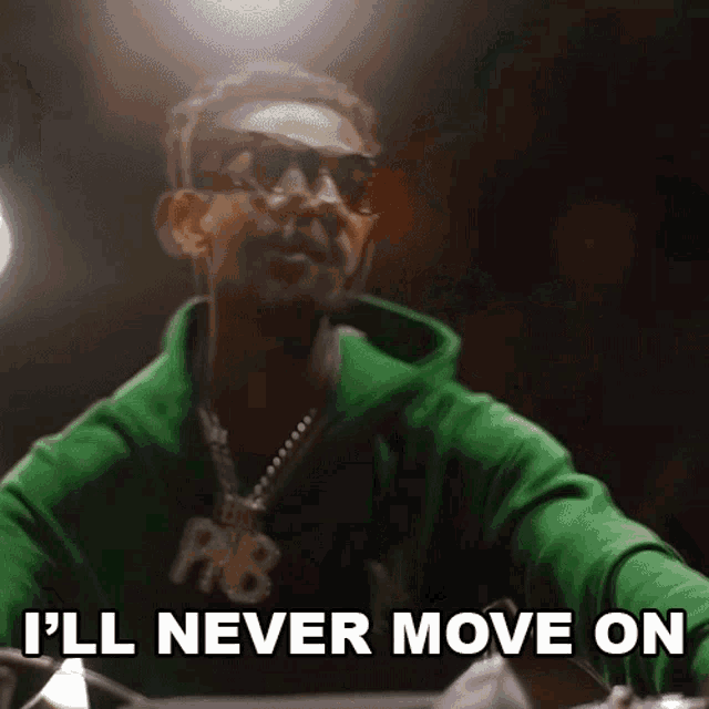 a man wearing sunglasses and a green hoodie says i 'll never move on