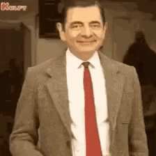 Mr. Bean smiles and gives a thumbs-up.