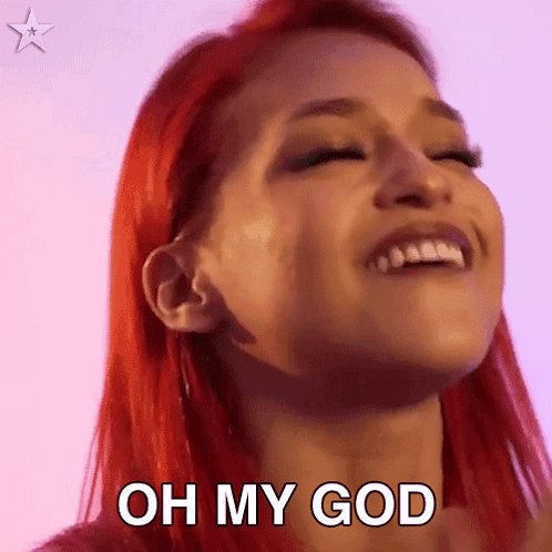 a woman with red hair is smiling and saying oh my god