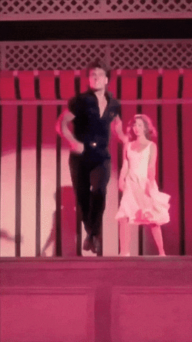 a man and woman are dancing on a balcony with a red background