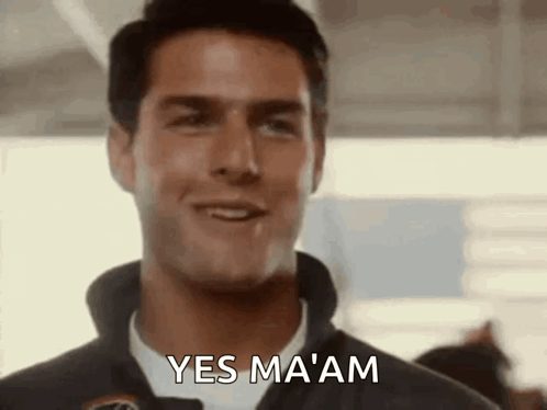A smiling pilot in a flight suit says “YES MA’AM.”
