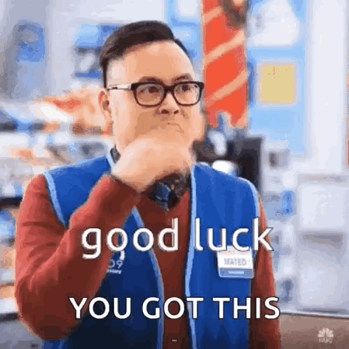 A bespectacled person makes the sign of the cross with the caption “good luck YOU GOT THIS.”