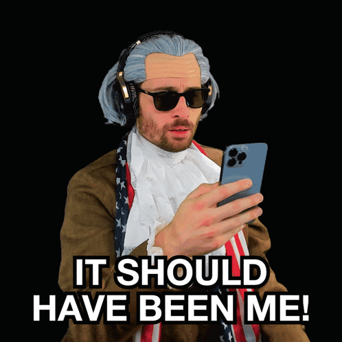 a man wearing a wig and sunglasses says " it should have been me "