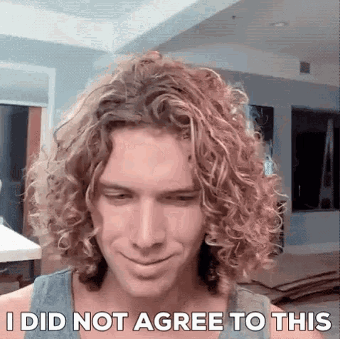 a man with curly hair is smiling and says i did not agree to this .