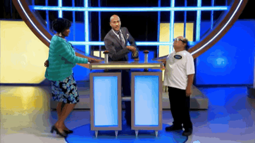 a man with a name tag on his shirt is standing next to a woman and a man
