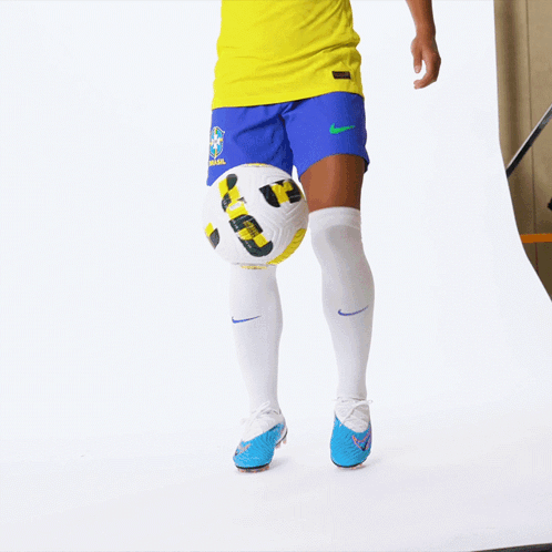 a woman wearing a yellow shirt that says ' soccer ' on it