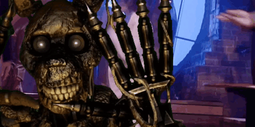 a skeleton is sitting in a chair with a sword in his hand .