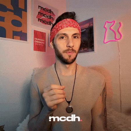 A man in a headband and necklace points while the caption reads “mcdh.”