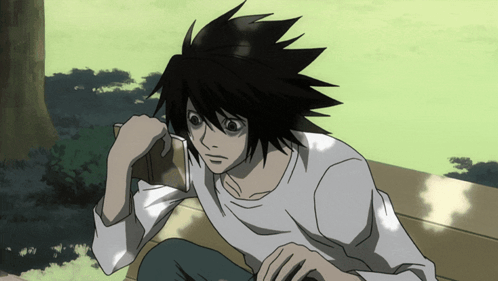 a man with black hair is sitting on a bench with his eyes closed