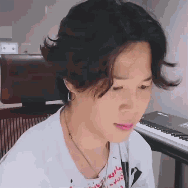 a close up of a person 's face with a keyboard in the background .