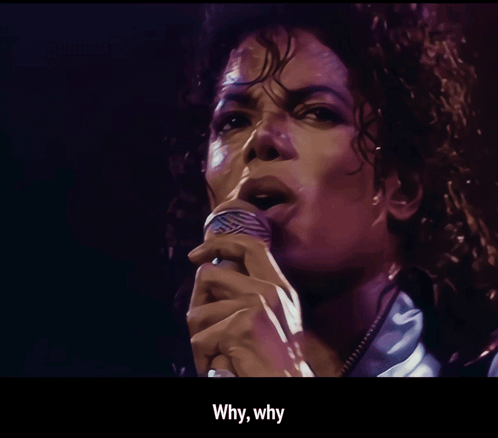 Michael Jackson sings into a microphone beneath the caption “Why why.”