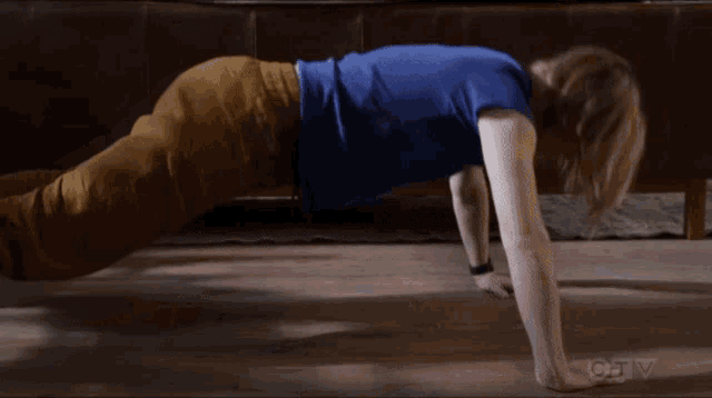 a person is doing push ups on the floor in a living room .