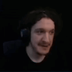 a close up of a man wearing headphones in a dark room .