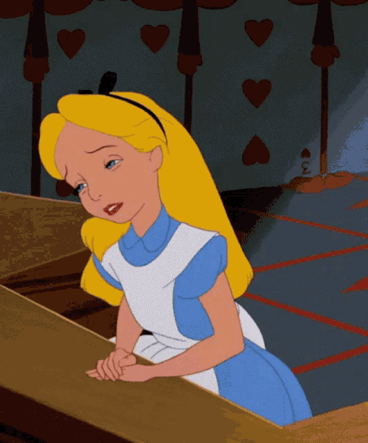 Alice in Wonderland rests her head on one hand, looking frustrated.