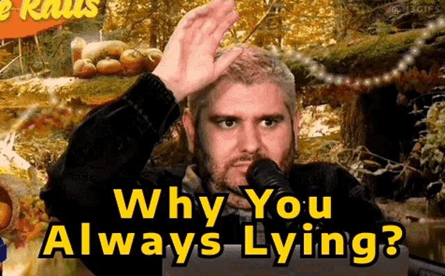 a man with a beard is talking into a microphone with the words why you always lying behind him
