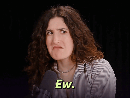 Kate Berlant makes a displeased face against a dark background with the caption “Ew.”
