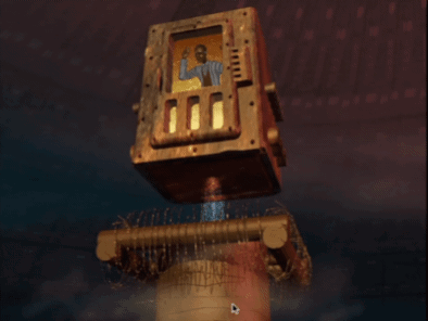 a computer screen shows a robot with a picture of a man on the screen