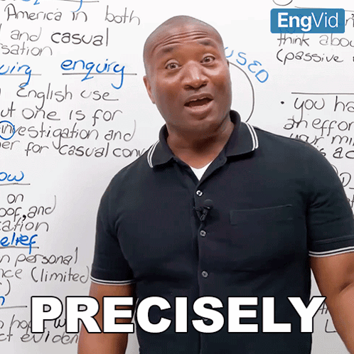 a man stands in front of a white board with the word precisely written on it