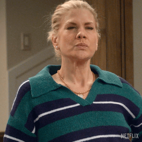 a woman wearing a green and blue striped sweater is a netflix advertisement