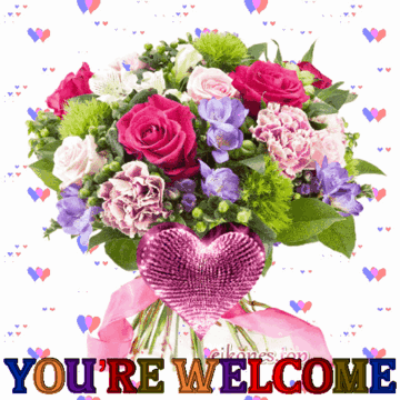 A bouquet of pink and purple flowers sits above a glittery heart.