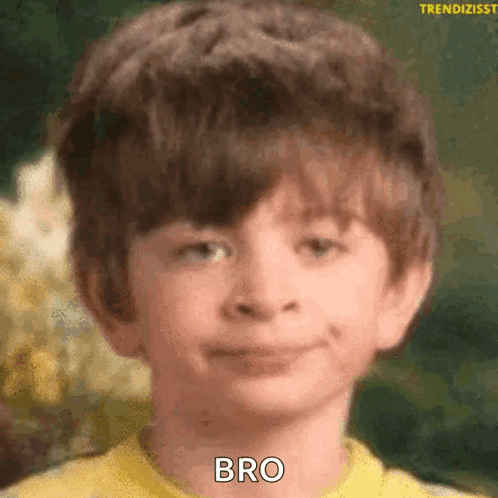 A young boy gives an unimpressed blank stare.
