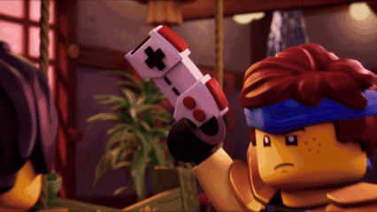 a lego man is holding a video game controller