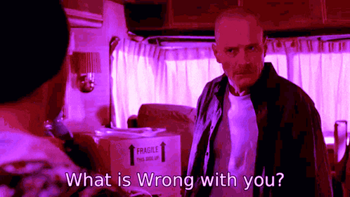 a man is standing in front of a box that says fragile on it and asking what is wrong with you .