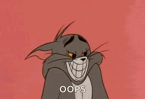 Tom from Tom and Jerry grins mischievously under the caption “OOPS.”