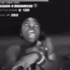 A dark blurry video frame shows a person reacting intensely.