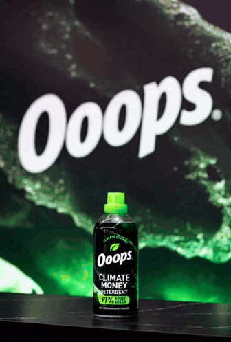 A green bottle sits below large white “Ooops” lettering on a dark green background.