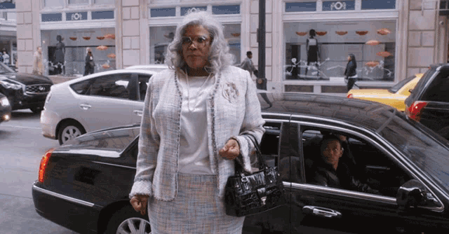a woman standing in front of a car with the word 101 on the side