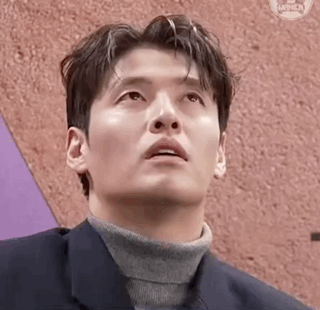 Kang Haneul looks upward with a concerned, thoughtful expression.